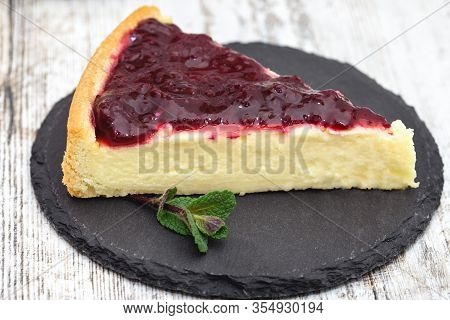 Delicious Dessert, Pleasure, Slice Of Cheesecake Topped With Blac Kberry Jam