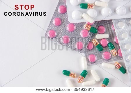 Coronavirus Phrase Text On A White Background With Medicines And Pills. The Concept Of The New 2019 