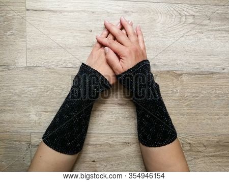 Black Fashionable Wool Knitted Wrist Warmers On The Woman Hands