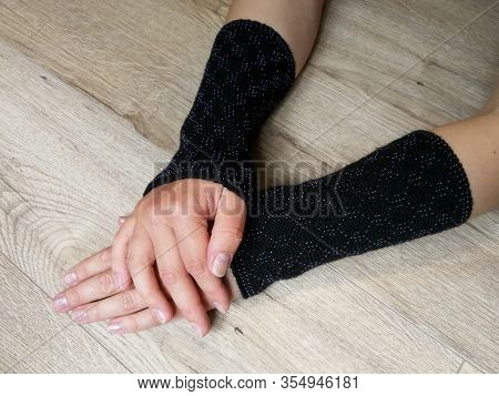 Black Fashionable Wool Knitted Wrist Warmers On The Woman Hands