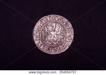 Ancient Grand Duchy Of Lithuania Coin Half-grosz Isolated On The Black Background