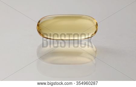 Source Vitamins Fish Oil Capsule Lies On Surface. Regulates Cholesterol And Lowers Sugar. Reduces Ri