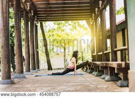 Girl Sitting Doing Split Meditation Yoga Outdoors, Woman Doing Side Split Yoga Outdoors, Young Woman