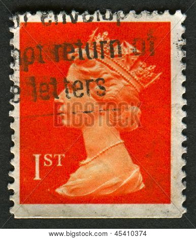 UK-CIRCA 1990:A stamp printed in UK shows image of Elizabeth II is the constitutional monarch of 16 sovereign states known as the Commonwealth realms, in red, circa 1990.