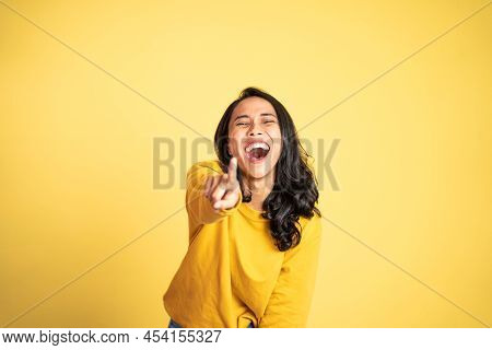 Woman With Finger Pointing At Frong And Laughing At Something