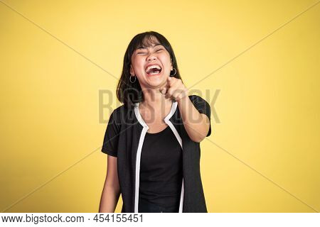 Woman With Finger Pointing At Frong And Laughing At Something