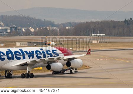 Zurich, Switzerland, March 2, 2022 A Towing Vehicle Is Taking An Edelweiss Air Airbus A340-313 Aircr