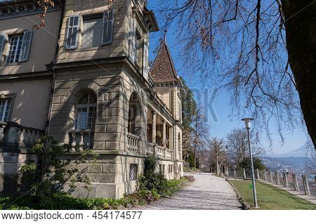 Lucerne, Switzerland, March 10, 2022 Old Historic Building In A Little Park At The Musegg Walls On A