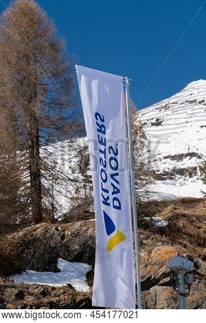 Davos, Switzerland, March 23, 2022 Flag With The Words Klosters And Davos Written On It Is Waving In