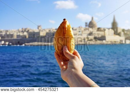Traditional Savoury Pastry Pastizzi From Malta With Valletta Old Town On Background, Malta Island