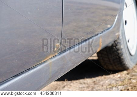 Car Door With Rust And Metal Corrosion. Lose Up Corrosion, Old Rusty Stain On Hood Car. Hard Corrosi