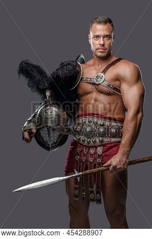 Muscular Gladiator Spearman With Helmet Against Grey Background