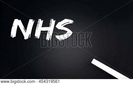 Nhs Text On Black Chalkboard With A Piece Of Chalk