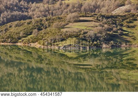 Picturesque Reservoir And Mountain Landscape In Riano. Mirror Effect. Spain