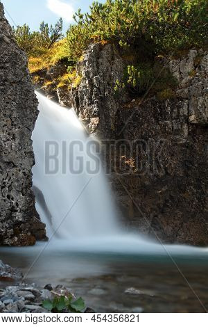 Mountain River Coming Out Of A Small Gorge In Austrian Alps