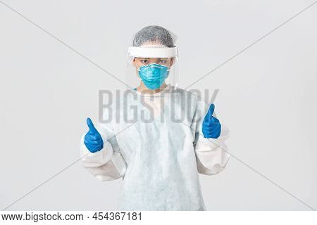 Covid-19, Coronavirus Disease, Healthcare Workers Concept. Serious-looking Confident Young Asian Fem