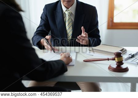 Law, Consultation, Agreement, Contract, Attorney Or Lawyer Holding A Pen Is Consulting With A Client