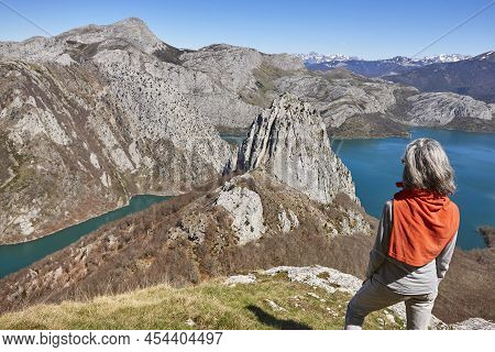Picturesque Reservoir And Mountain Landscape In Riano. Hikkers. Spain