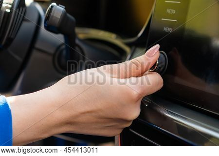 Close Up Woman In Blue Blazer Change The Volume On The Infotainment Sitting In The Car.
