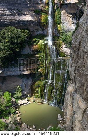 Waterfall In The Salt De Sallent Cliffs In The Medieval City Of Rupit And Pruit. Catalonia. Spain