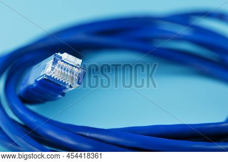 Blue Ethernet Cable Cord Patch Cord On A Blue Background With Free Space