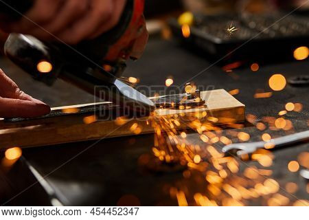 Close Up Locksmith Works With Grinder Machine, Fly Bright Sparks.