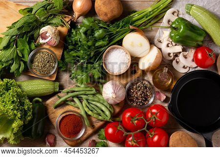 Assortment Of Vegetables, Herbs And Spices On Wooden Table Background