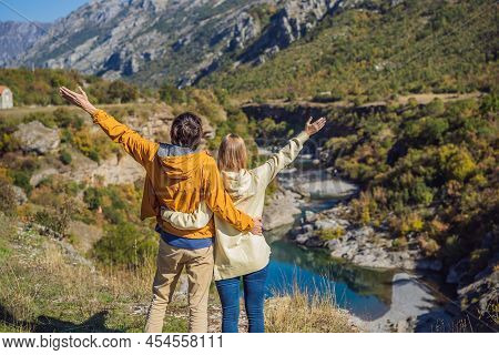 Montenegro. Happy Couple Man And Woman Tourists On The Background Of Clean Clear Turquoise Water Of 