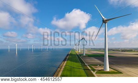 Offshore Windmill Farm In The Ocean Westermeerwind Park, Windmills Isolated At Sea On A Beautiful Br