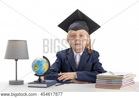 Straight-a Student Sits At Table Next To Notebooks, Textbook And Globe. Schoolboy In School Uniform 