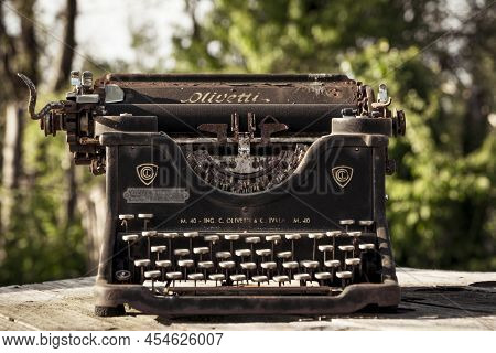 Ciney, Belgium, May 2022: Olivetti Retro And Vintage Typewriter. Worn-out And Rusty Due To Weather A