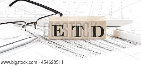 Etd Written On Wooden Cube With Keyboard , Calculator, Chart,glasses.business Concept