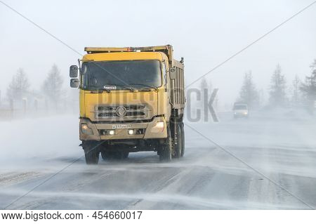 Novyy Urengoy, Russia - April 20, 2022: Yellow Dump Truck Dongfeng Dfl3251 In A City Street During A