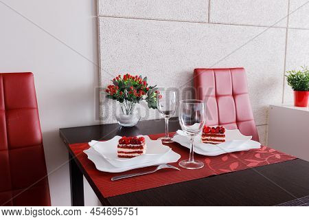 Cakes And Glasses Are On The Table