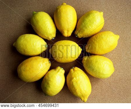 Flatlay Photo Of Lemons On A Table. Top View Of Lemons Arranged In The Shape Of A Flower. Food Backg