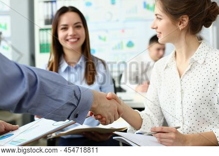 Portrait Of People Get To Know Each Other In New Group, Shake Hands Over Business Papers. Greeting N