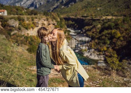 Montenegro. Mom And Son Tourists On The Background Of Clean Clear Turquoise Water Of River Moraca In