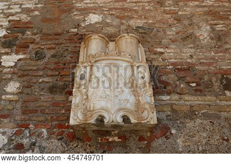 Malaga, Spain, May 8, 2022: Heraldic Coat Of Arms Outside The Alcazaba Of Malaga. Palatial Fortifica