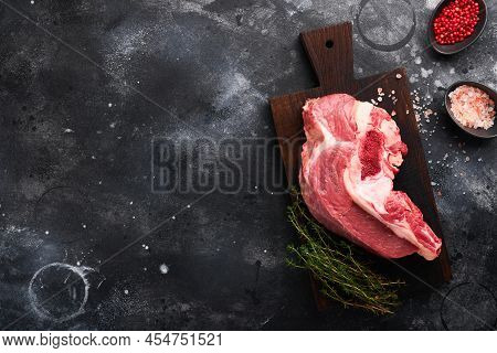 Raw Beef Meat. Rough Piece Of Meat On Bone For Roast Or Soup With Salt, Pepper, Thyme And Rosemary O