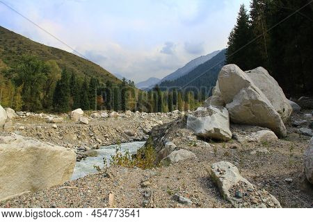 A River With Huge White Stones On The Banks In The Talgar High-mountain Gorge With A Forest And A Vi