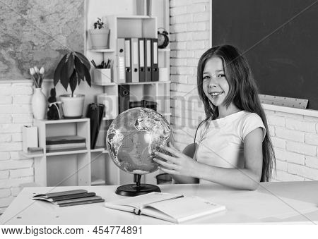 Cute Teen Girl Near Chalkboard With Geaography Globe, Back To School