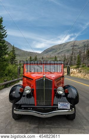 Glacier National Park, United States: July 26, 2021: Red Jammer Parked At Wild Goose Island Overlook