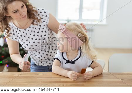 Mother Fixing Her Daughters Cochlear Implant Hearing Aid - Deafness And Diversity Concept. Innovativ