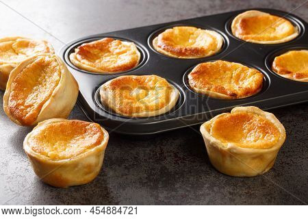 Traditional Portuguese Cheesecakes Called Queijadas De Sintra Close-up In A Baking Dish On The Table