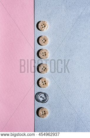 A Row Of Buttons, One Of Them Special, Lies On A Blue And Pink Background. Minimalist Concept.