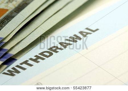 Closeup of bank withdrawal slip with US currency