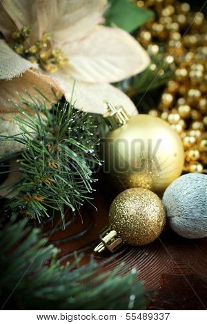 Christmas decoration with christmas balls, golden beads and poinsetia as ornament
