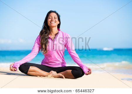 Happy relaxed young woman practicing yoga outdoors at the beach. Healthy natural lifestyle.
