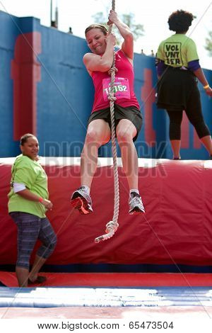 Young Woman Swings With Rope In Crazy Obstacle Race