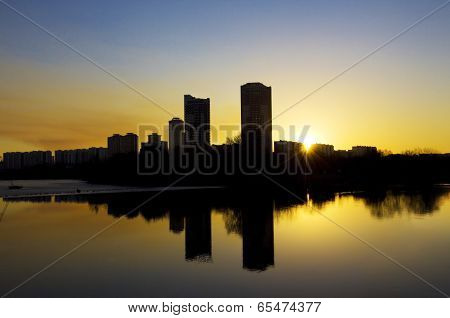 Sunset In The City, Reflcting In Smooth Water